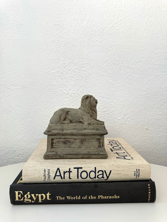 Lounging stone lion statue on base | vintage shelf decor