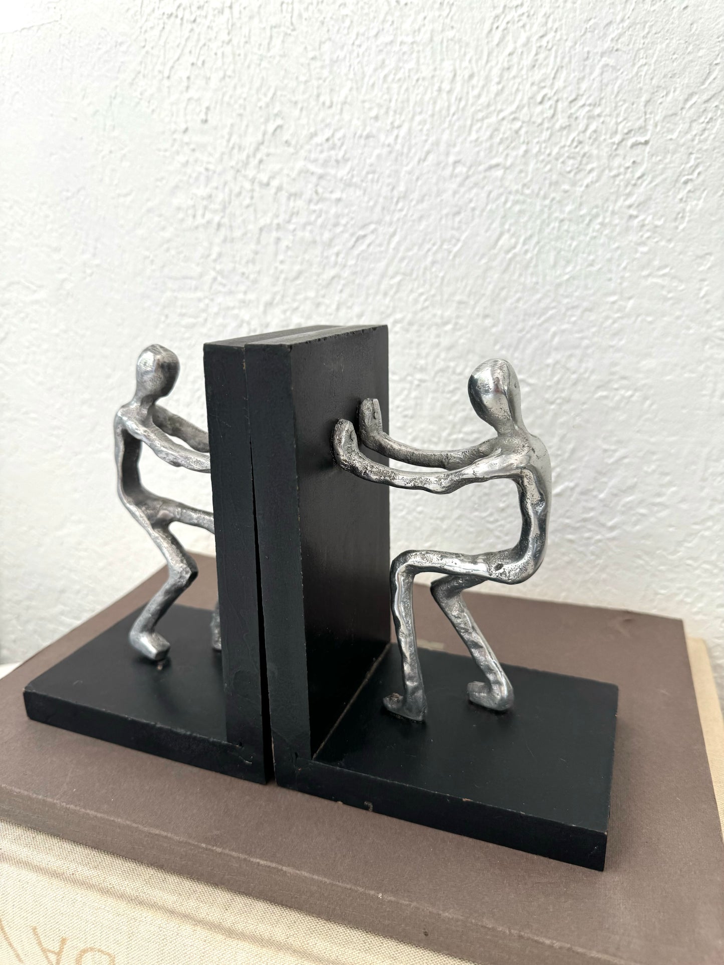 Silver metal men pushing sculpture bookends | Set of 2