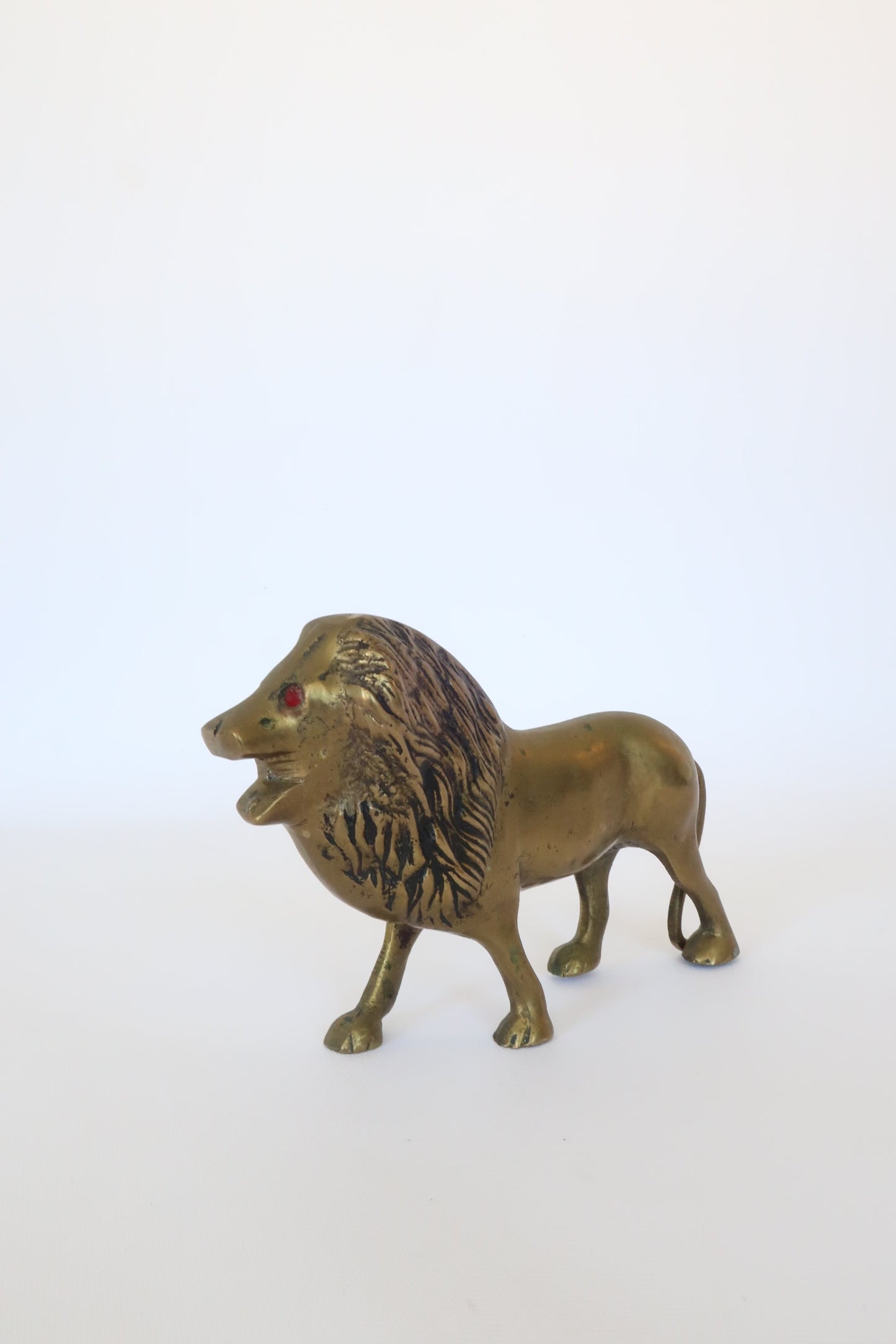 MCM brass lion sculpture w/ ruby red eyes