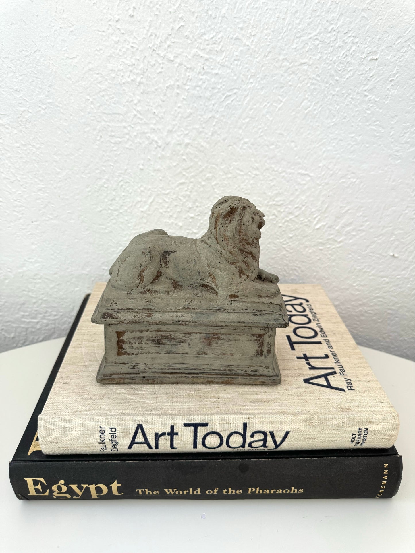 Lounging stone lion statue on base | vintage shelf decor